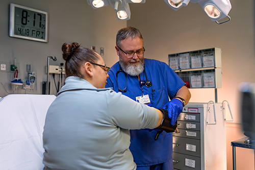 UTMC nurse helping a patient in the emergency room