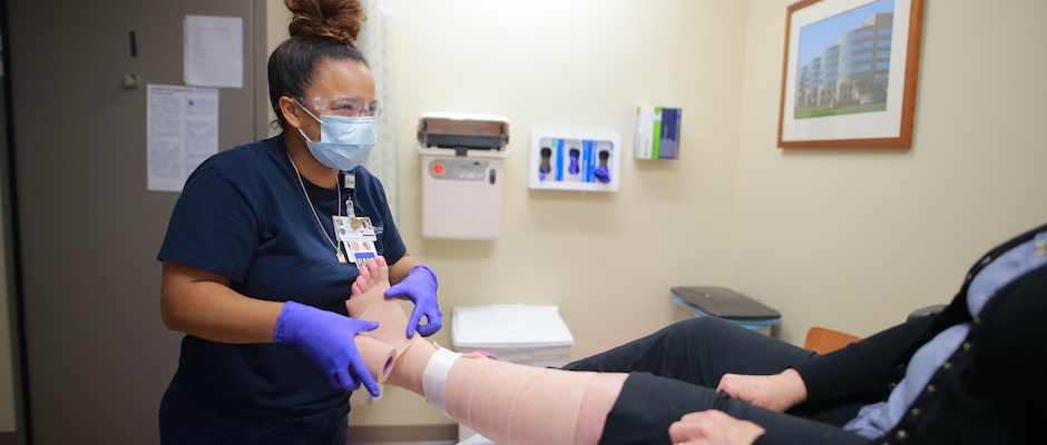 Provider wrapping a patient's leg