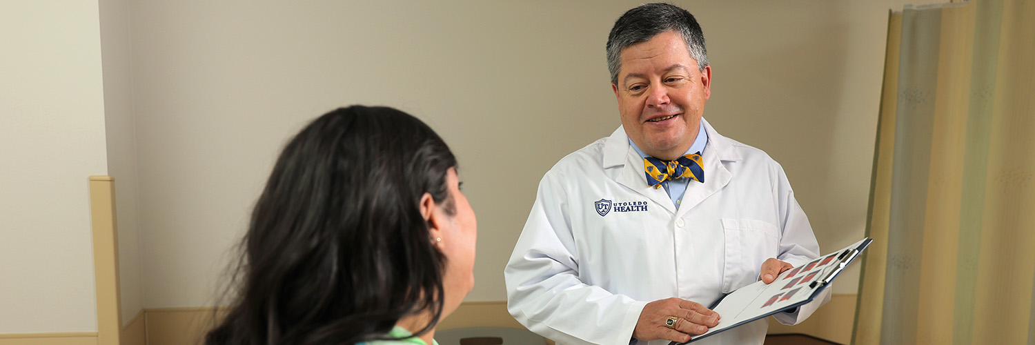 Provider discussing results with patient holding a clip board.