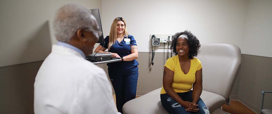 Patient with medical assistant and doctor