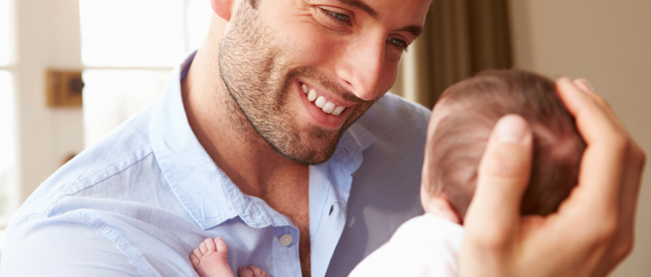 Man holding newborn 