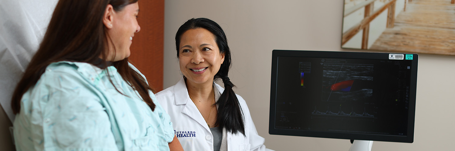 Doctor smiling at patient in exam room