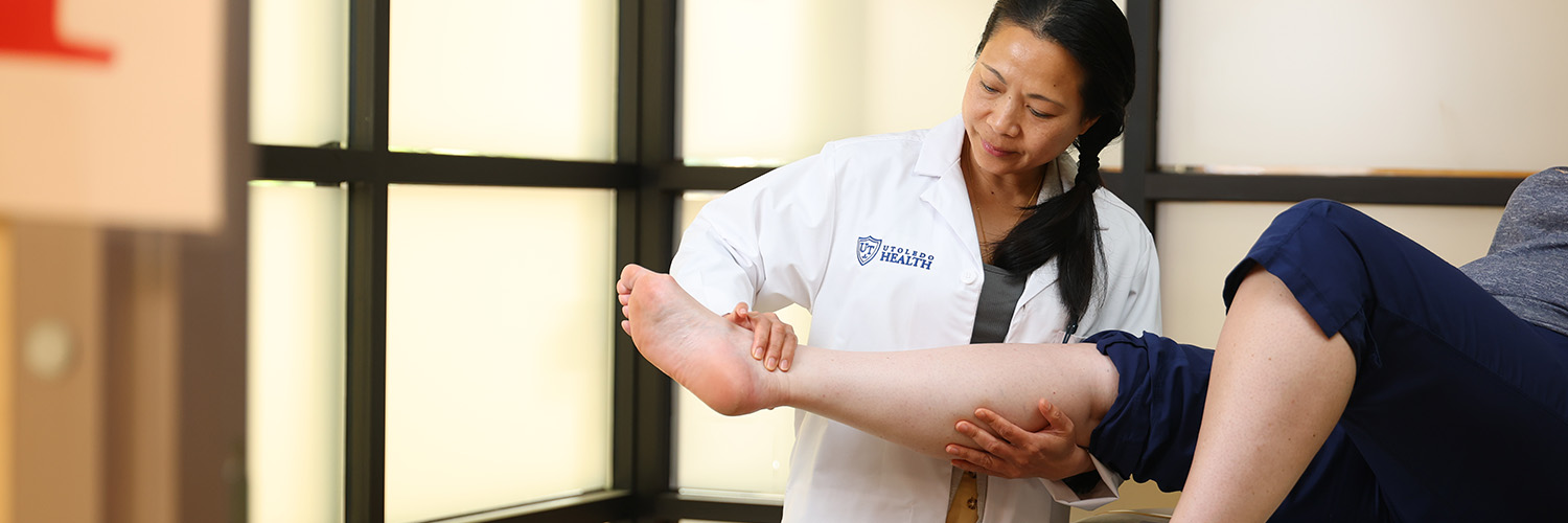 Doctor examining patient's leg