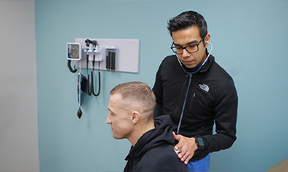 Dr.Yadav with patient Taylor Iceman listening to his lungs after surgery kidney and pancreas transplant surgery