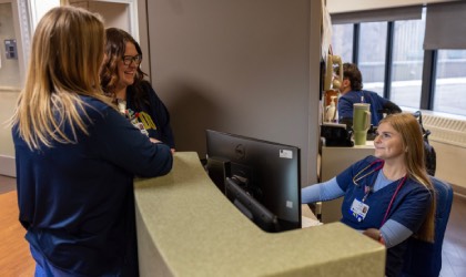 UTMC nurses chatting at a work station.