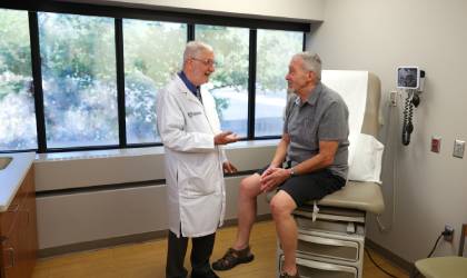 Dr. Blair Grubb, a cardiologist with UToledo Health, speaks with his longtime patient Chris Bowers. Grubb diagnosed Bowers with POTS 20 years and has successfully helped him manage his disease.